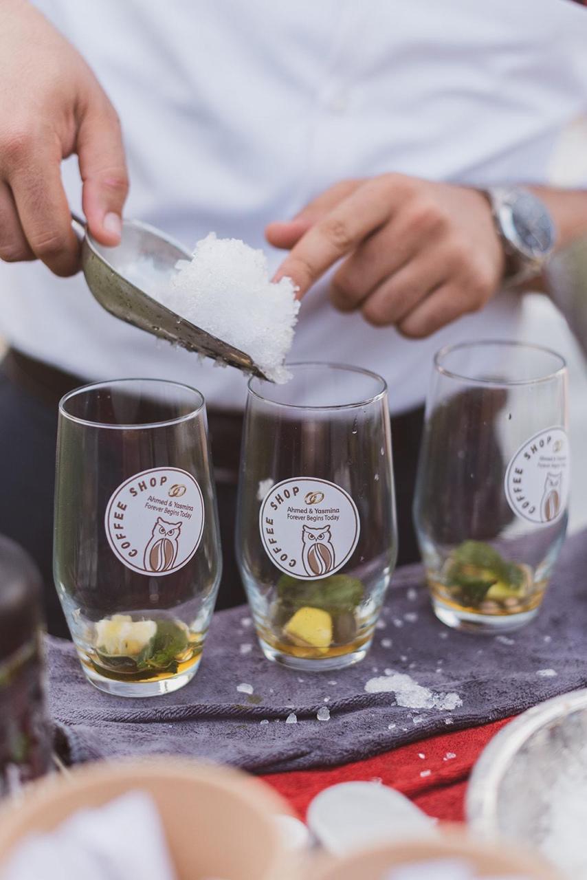 Ice being added to branded Coffee Moca glasses